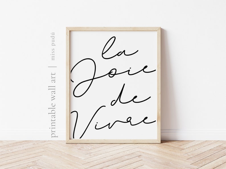 Puede incluir: Una impresi&oacute;n de arte de pared imprimible en blanco y negro con el texto "La Joie de Vivre" en una fuente cursiva.