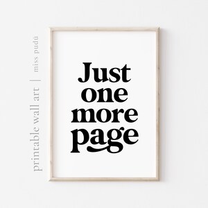 May include: A framed print with the text "Just one more page" in black bold font on a white background.