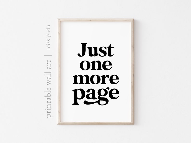 May include: A framed print with the text "Just one more page" in black bold font on a white background.