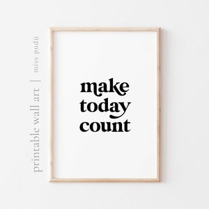 May include: A printable wall art print with a white background and black text that reads "make today count". The print is framed in a light wood frame.