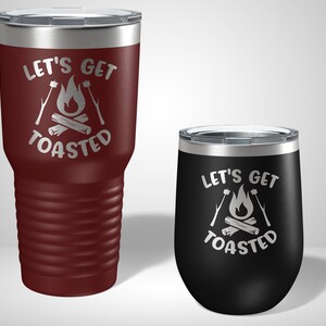 May include: Two stainless steel tumblers with a campfire design and the text "Let's Get Toasted". The larger tumbler is maroon and the smaller tumbler is black.