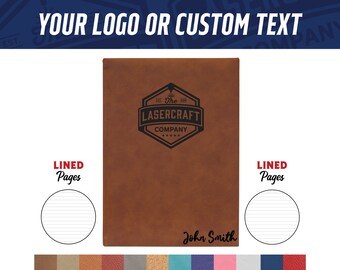 May include: A brown leather-bound journal with lined pages. The front cover features a black and white logo with the text "The Lasercraft Company" and a design of a laser beam. The name "John Smith" is also engraved on the front cover.