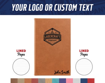 May include: A brown leather-bound journal with a black logo that says "The Lasercraft Company" and a black inscription that says "John Smith". The journal has lined pages.