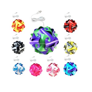 May include: Nine different colored, modular, 3D, paper, light fixtures. The lights are in the colors red, black, yellow, green, silver, white, pink, blue, and turquoise. Each light has a white cord and plug.