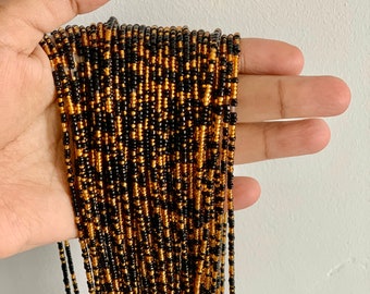 Cadena africana para el vientre con cuentas negras y doradas