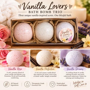 May include: A rectangular box containing three spherical bath bombs in shades of light pink, cream, and pale purple. The box features the text Vanilla Lovers Bath Bomb Trio. Each bath bomb is nestled in brown paper within the clear-topped packaging.