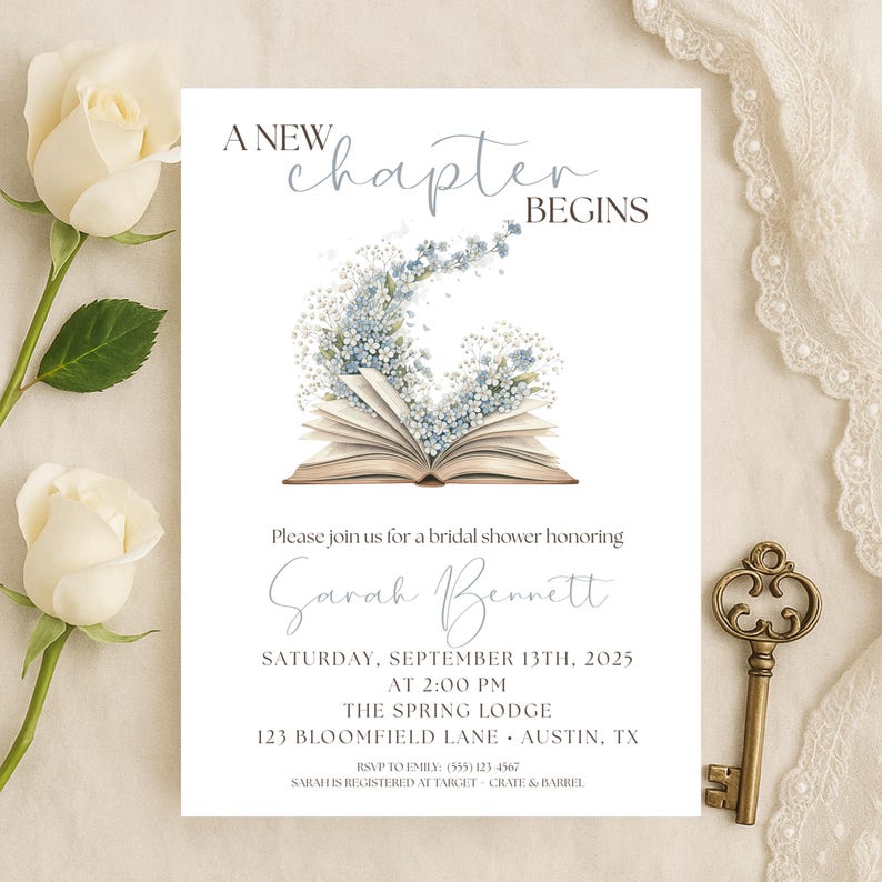May include: A white invitation card with the text "A New Chapter Begins" and details for a bridal shower. The card features an open book with blue floral accents and the name "Sarah Bennett". A decorative key is on the right.