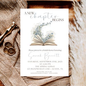 May include: Bridal shower invitation with the text "A New Chapter Begins." The invitation features an open book with blue floral accents. Details include the honoree's name, date, time, and location.