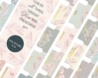May include: A set of Bible tabs with floral designs in pastel colors. The tabs feature gold lettering with book names and a quote from Philippians 4:13: "I can do all things through Him who strengthens me."