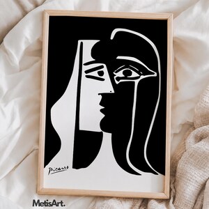 May include: A rectangular framed print featuring a high-contrast black and white abstract portrait. The artwork displays a stylized face with bold lines and shapes. The signature Picasso is visible in the bottom left corner, and MetisArt is printed below.
