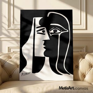 May include: A rectangular canvas print featuring a high-contrast black and white graphic illustration of a stylized face in profile. The artwork displays bold, clean lines and geometric shapes, with the signature Picasso printed in the bottom left corner.