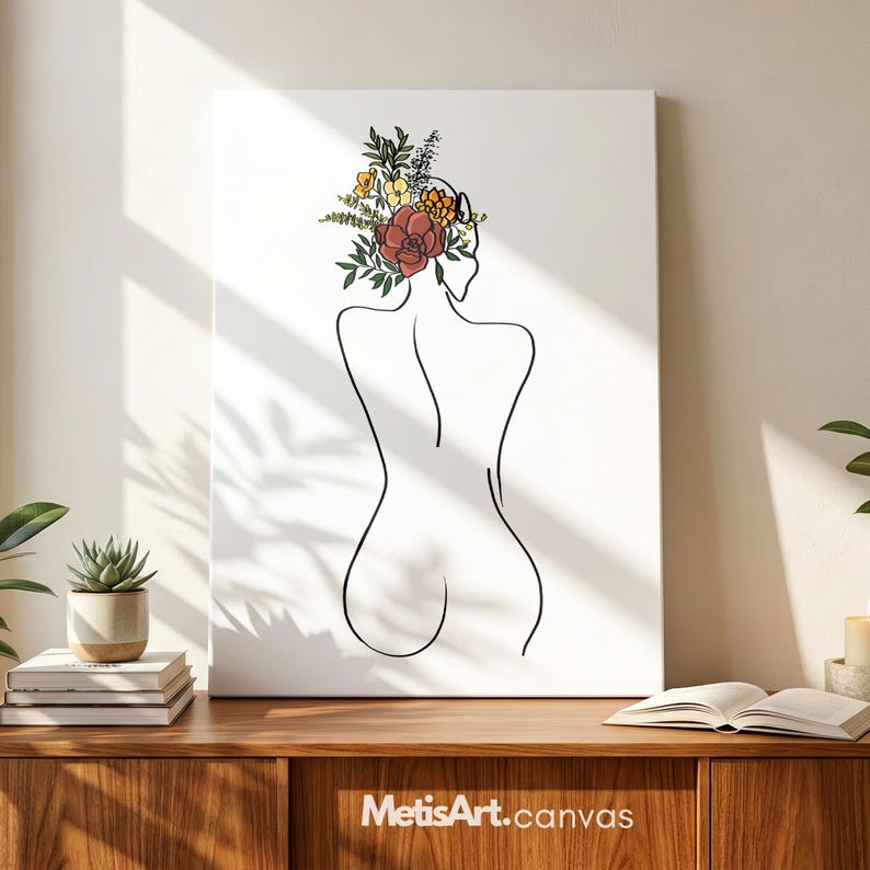 May include: A rectangular canvas print featuring a black line art drawing of a person's back. The person has a colorful floral arrangement in shades of red, yellow, and green resting on their head. The background of the canvas is white.