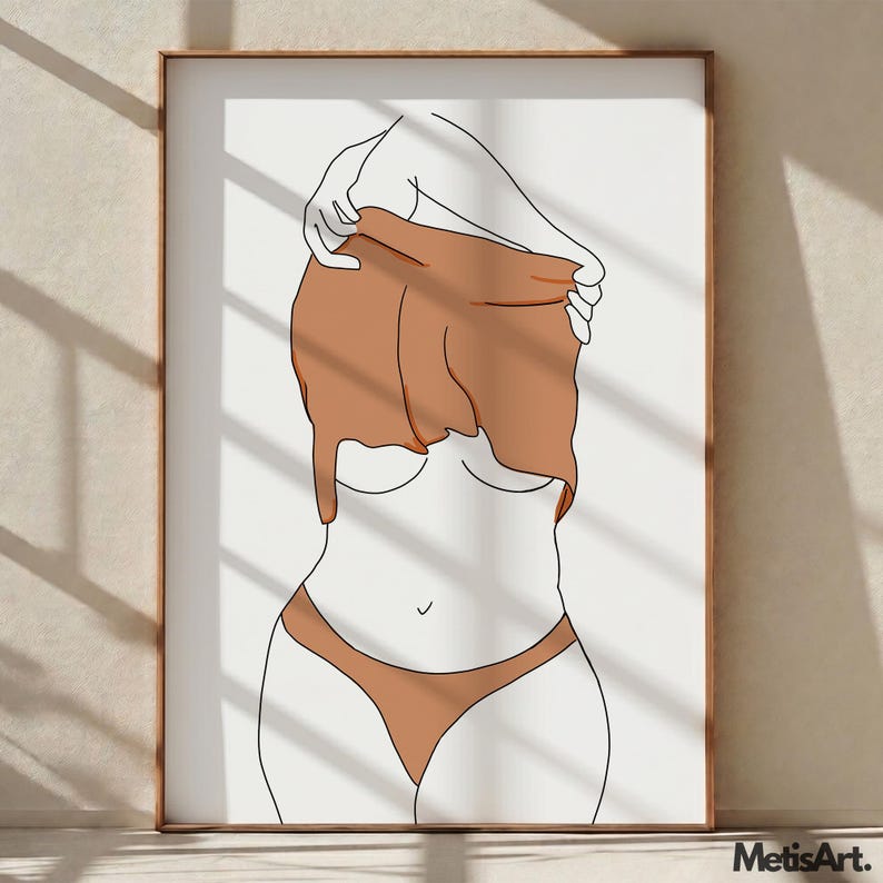 May include: Minimalist art print featuring a line drawing of a figure partially undressing. The artwork uses a palette of white, brown, and black. The figure is wearing brown underwear and a brown top. The artwork is framed in a wooden frame.