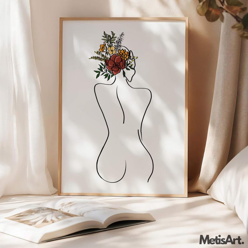 May include: A framed wall art print featuring a black line drawing of a person's back with a bouquet of colorful flowers in shades of red, orange, yellow, and green resting on the head. The artwork is displayed in a light wood frame.