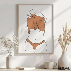 May include: Framed minimalist art print featuring a line drawing of a figure partially undressing. The artwork uses a palette of white, brown, and black. The figure is wearing brown underwear. The print is displayed on a white wall with decorative vases.