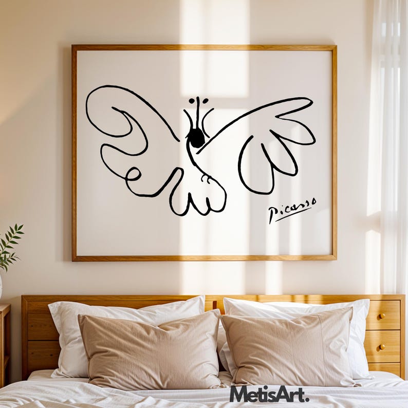 May include: A framed wall art print featuring a black line drawing of a butterfly on a white background. The artwork includes the signature Picasso in the bottom right corner. The frame is made of light-colored wood with a simple rectangular design.