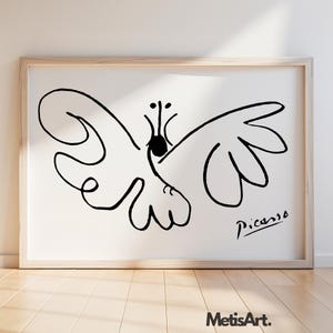 May include: A framed wall art print featuring a black line drawing of a butterfly on a white background. The artwork displays a stylized, fluid insect form with symmetrical wings and a signature reading Picasso in the bottom right corner.