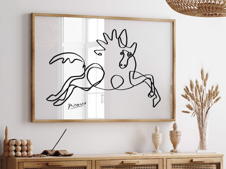 Black-and-white art print of a horse in mid-jump, sketched in continuous looping lines with Picasso’s signature below.