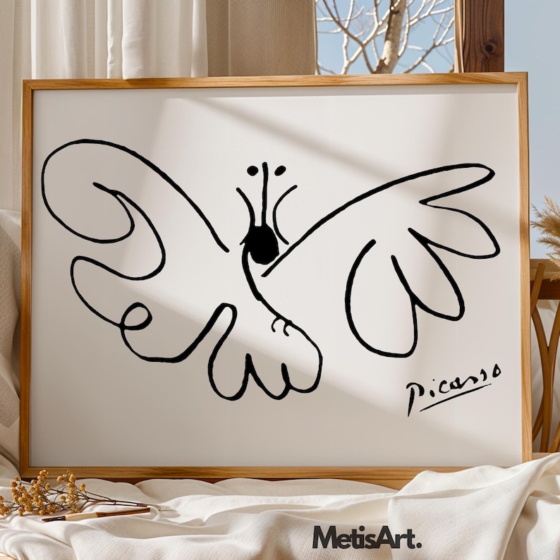 May include: A framed wall art print featuring a black line drawing of a butterfly on a white background. The artwork includes a black signature that reads Picasso in the bottom right corner. The frame is made of light-colored wood.