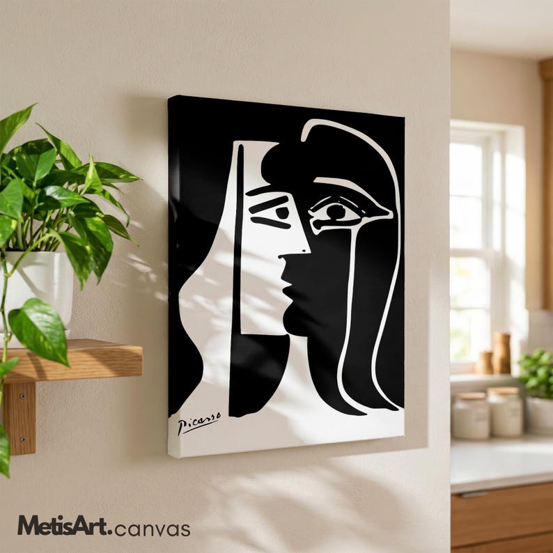 May include: A rectangular canvas wall art piece featuring a high-contrast black and white abstract portrait. The graphic design displays a stylized face with bold lines and the signature Picasso printed in the bottom left corner of the artwork.
