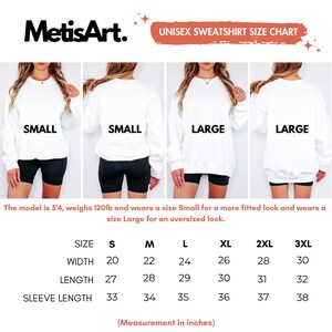 May include: A white unisex sweatshirt size chart with measurements in inches. The chart includes sizes S to 3XL, with width measurements from 20 to 30 inches, length from 27 to 32 inches, and sleeve length from 33 to 38 inches. The model is 5'4, weighs 120lb.