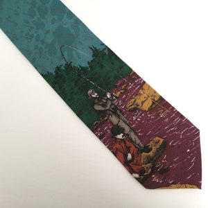 May include: A green, purple, and yellow tie with a print of two people fishing on a riverbank.