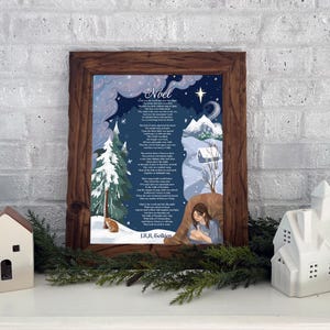May include: A framed print with a winter scene and the word "Noel" at the top. The artwork features a snowy landscape, a Christmas tree, and a poem. Decorative white ceramic houses and greenery are in the foreground.