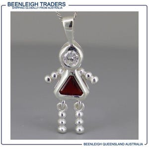 May include: Silver charm pendant in the shape of a stick figure with a red triangular gem and a clear rhinestone for a head.