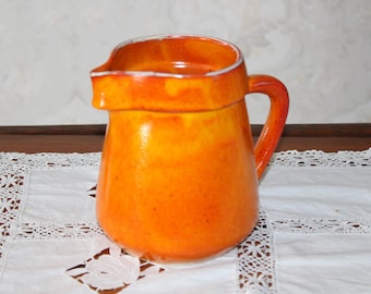 large milk jug ceramic orange jug from the pottery