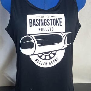 May include: Black tank top with a white graphic of a cannon and the text "Basingstoke Bullets Est. 2011 Roller Derby"