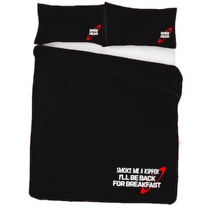 May include: Black bedding set with a red and white logo that says "Smeg Head" on the pillowcases. The duvet cover has a red and white logo that says "Smoke me a kipper I'll be back for breakfast".