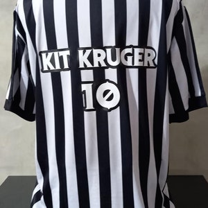 May include: Black and white striped jersey with the name "Kit Kruger" and the number "10" on the back.