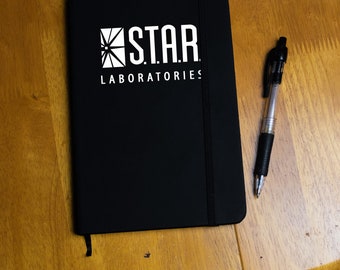 Black A5 Star Lab lined Notebook with white or gold text Flash star Laboratories