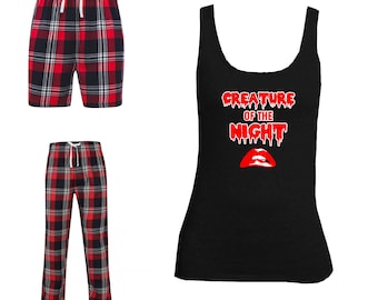May include: Red and black plaid pajama pants and shorts with a black tank top that says "Creature of the Night" in red dripping letters with a red dripping mouth underneath.