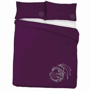May include: Purple duvet cover featuring a grey dragon and pentagram design. Two matching pillowcases with a pentagram design.