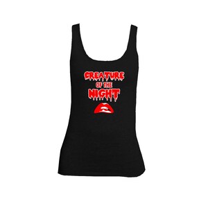 May include: Black tank top with a red graphic that says "Creature of the Night" with dripping blood and a red lip print.