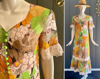 May include: A vintage maxi dress with a floral print in shades of brown, green, orange, and white. The dress has a lace trim and a button-up front.