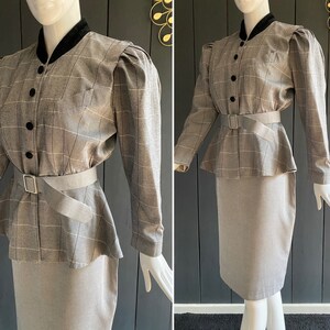 May include: A gray and white plaid skirt suit with a black velvet collar and a black belt. The jacket has puffed shoulders and a peplum hem. The skirt is a pencil skirt.