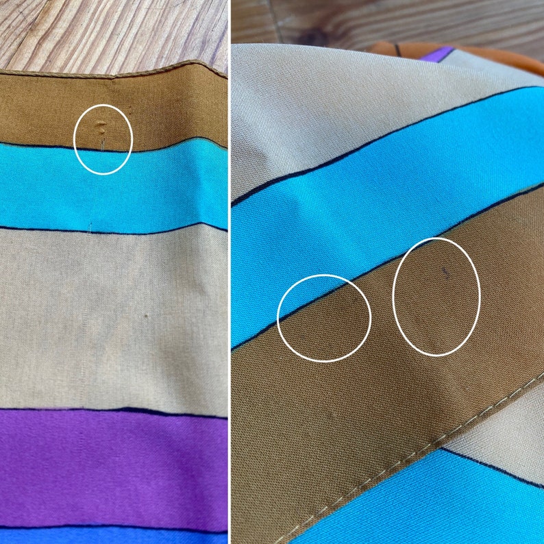 May include: A striped fabric with brown, blue, beige, purple, and orange stripes. The fabric has some small imperfections.
