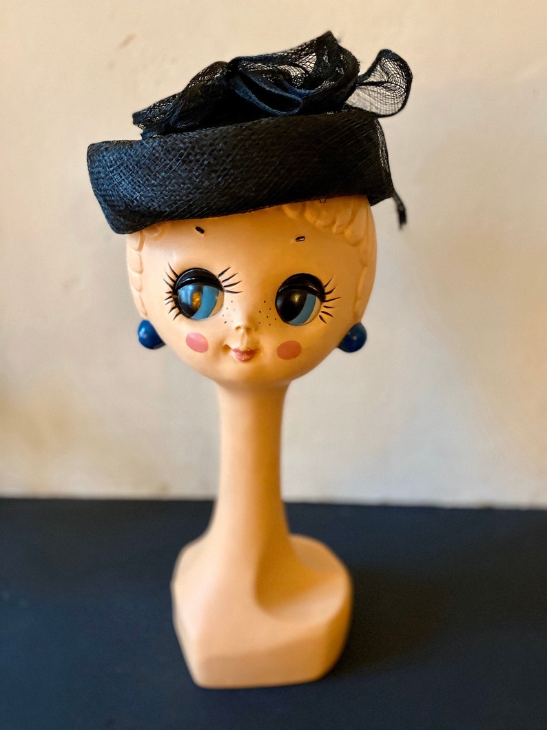 Vintage 60s black fine straw mini hat covered with a net and adorned with clever aerial volutes T 55