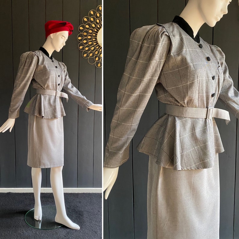 May include: A gray plaid skirt suit with a peplum top and a black velvet collar. The skirt is knee-length and the jacket has long sleeves with puffed shoulders.