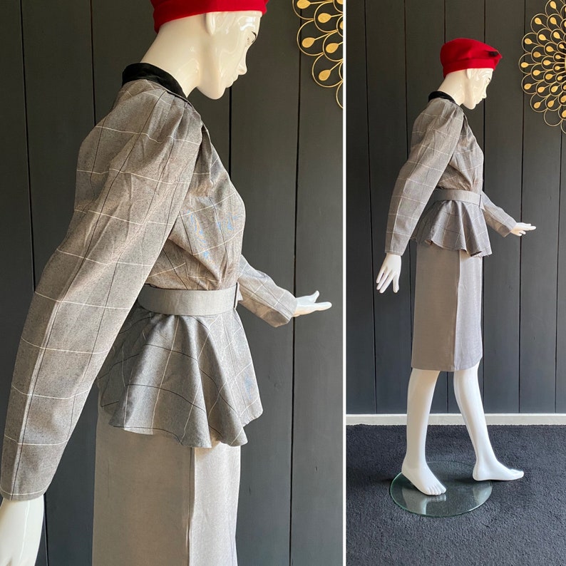 May include: A gray plaid blazer with a black velvet collar and a matching skirt. The blazer has a peplum hem and a belt. The skirt is knee-length.