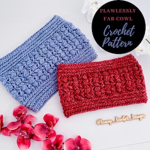 May include: Two crocheted cowl neck warmers, one blue and one red, laid out on a white surface. The text "Flawlessly Fab Cowl Crochet Pattern" is visible in a black circle above the cowls. The text "@Teacup_Crochet_Designs" is visible on a wooden tag below the cowls.