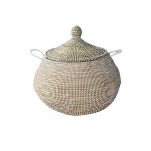 May include: A round, woven basket with a matching conical lid and two small side handles. The basket features a neutral color palette with alternating light beige and off-white horizontal bands, creating a textured, coiled appearance throughout.