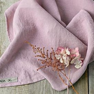 May include: A pale pink linen kitchen towel with a small tag that says "LILLA & CO."