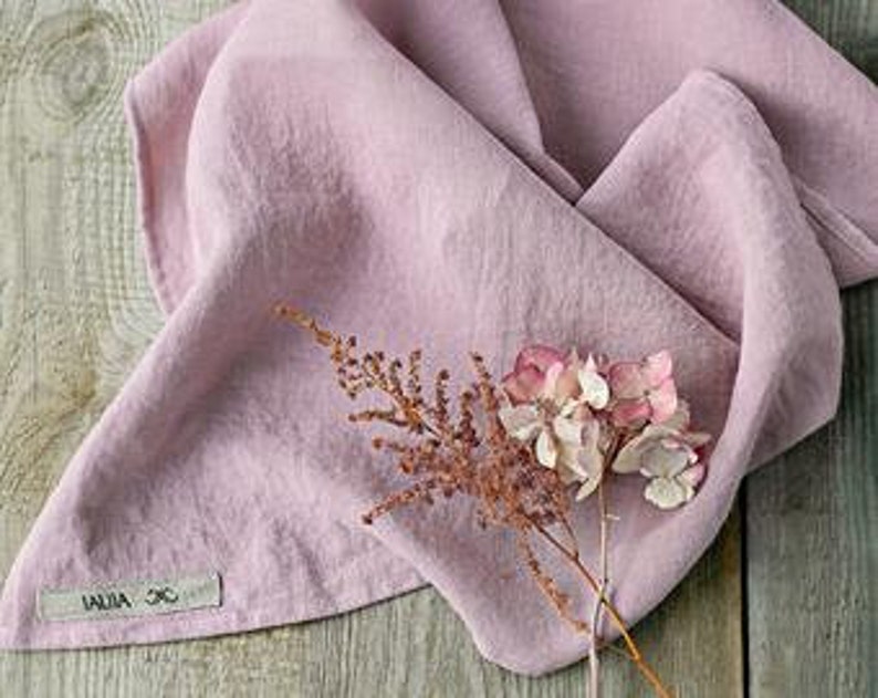 May include: A pale pink linen kitchen towel with a small tag that says "LILLA & CO."