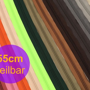 Könnte beinhalten: Sortiment von 55 cm langen Reißverschlussbändern in verschiedenen Farben, darunter Rot, Orange, Rosa, Beige, Grün, Schwarz, Braun und Grau. Die Reißverschlussbänder sind in Reihen angeordnet und bereit für Nähprojekte.