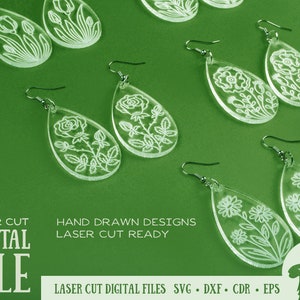 May include: A set of laser cut earrings featuring floral designs. The earrings are made of clear acrylic and have a teardrop shape. The designs are intricate and delicate, and the earrings are perfect for adding a touch of elegance to any outfit.