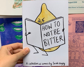 May include: A white comic book cover with a yellow onion character reading a book titled "HOW TO NOT BE BITTER." The comic book has black text and is held by a person. The bottom of the cover reads "A collection of comics by Sarah Hingley."
