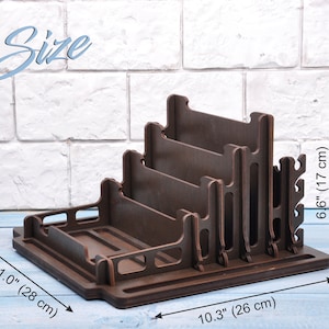 May include: A dark brown wooden stand with five slots for organizing items. The stand measures 11.0 inches wide, 10.3 inches deep, and 6.6 inches tall.  The stand has a small shelf at the bottom and a series of hooks on the side.